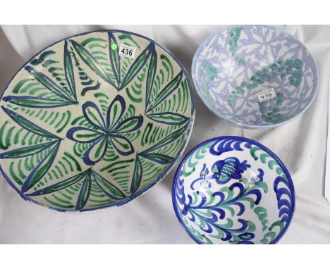 Three large glazed ceramic bowls , green/blue floral design 