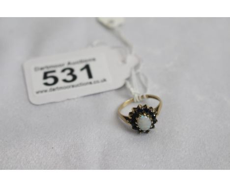 9 ct Gold ring sapphires surrounded opal centre 
