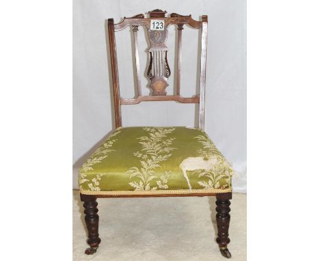 A fine Regency style chair with intricately carved and inlaid lyre back, ceramic castors, upholstery fabric needs renovation 