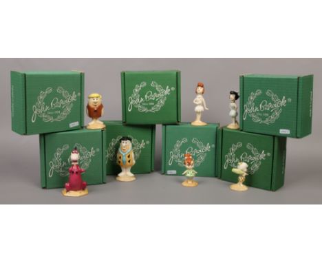 Seven boxed John Beswick ceramic Flintstone figures.