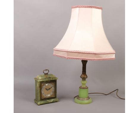 An onyx cased mantle clock by David Hall along with an onyx effect and brassed table lamp with silk shade.