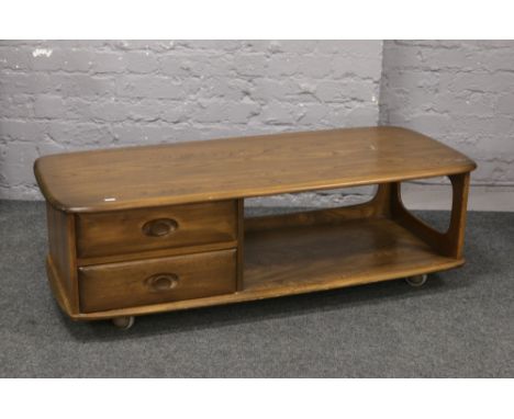 An Ercol Golden Dawn two tier coffee table incorporating two drawers to one end, 125cm x 53cm x 40cm.Condition report intende