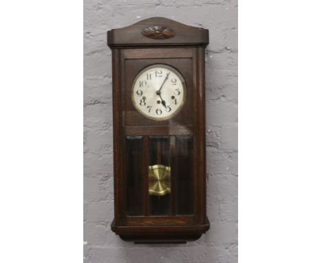 A mahogany cased wall clock with silvered dial and Arabic numeral markers.