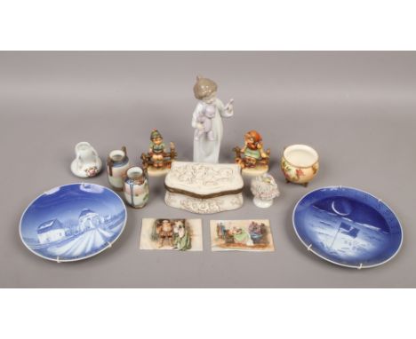 A box of pottery and porcelain including Nao figure, pair of porcelain plaques painted with Shakespearean scenes and Hummel f