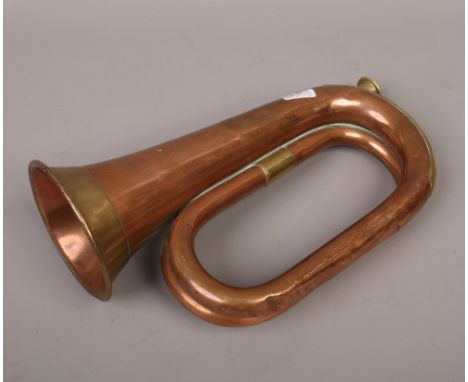 A military issue copper and brass bugle by Loosey &amp; Hawkes Ltd, stamped 1946 and with a broad arrow mark.