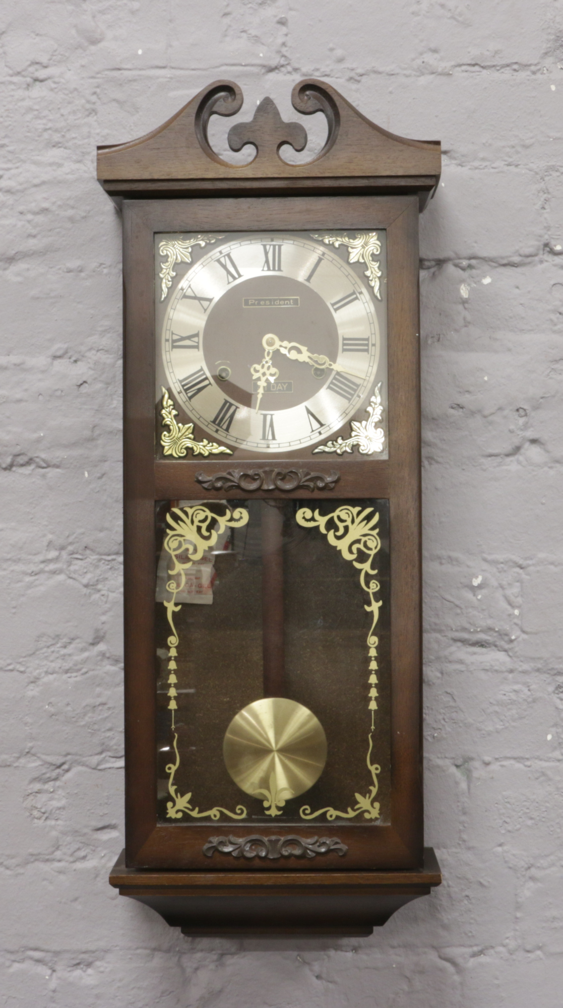 A President 31 day wall clock chiming on a coiled gong.