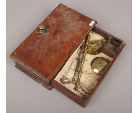 A mahogany cased set of late 19th / early 20th century brass weighing scales.