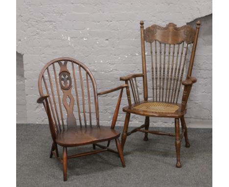 An Ercol spindle back arm chair along with a carved ash and elm bergere seat arm chair.