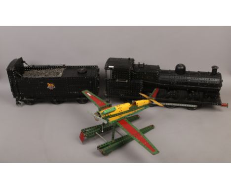 Three large Meccano models, a train with tender and a sea plane.