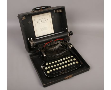 A vintage cased folding typewriter by L.C.Smith &amp; Corona typewriters including USA with original instruction manual.