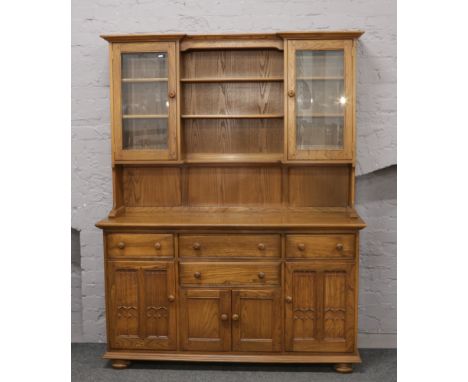 An Ercol Golden Dawn dining room dresser, 155cm x 200cm H x 52cm D.