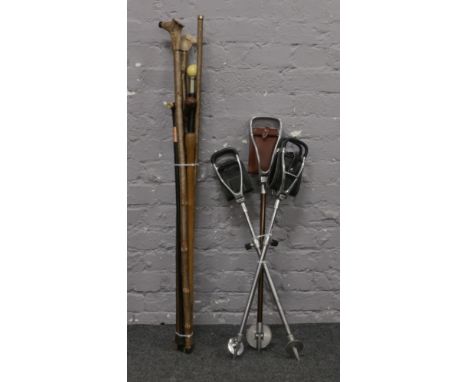 Seven walking sticks to include antler handle, dogs head and miners yard stick, along with three shooting sticks.