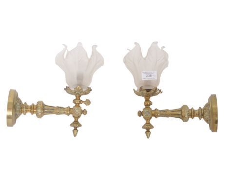 A matching pair of 19th Century Victorian worked brass wall light sconces with each having frosted glass leaf like shades upo