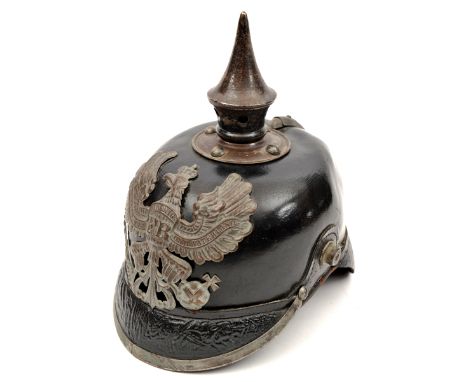 A Prussian pickelhaube, the leather skull with steel fittings, including line eagle badge, the inside with printed labels bea