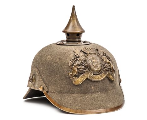 A Bavarian ersatz felt pickelhaube, the one piece skull with brass mounts (including rim to peak) and badge, and with leather