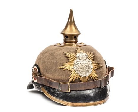 A Saxon pickelhaube, with leather lined khaki felt skull,  patent leather peak and neck guard, bi-metal badge, brass mounts, 