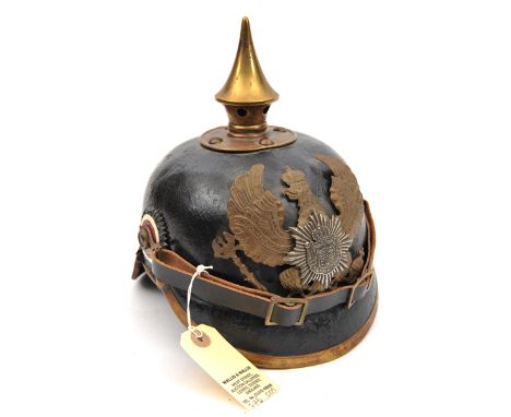 A German pickelhaube,  the leather skull with brass fittings, the inside and neck guard with indistinct regimental and maker’