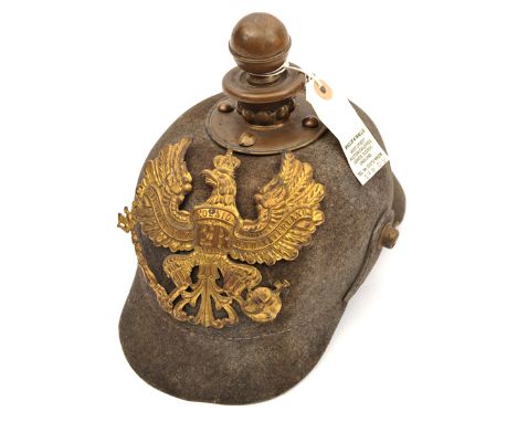 A Prussian ersatz felt Kugelhelm, the one piece skull with brass line eagle badge, ball finial with perlring, and rear rib, t