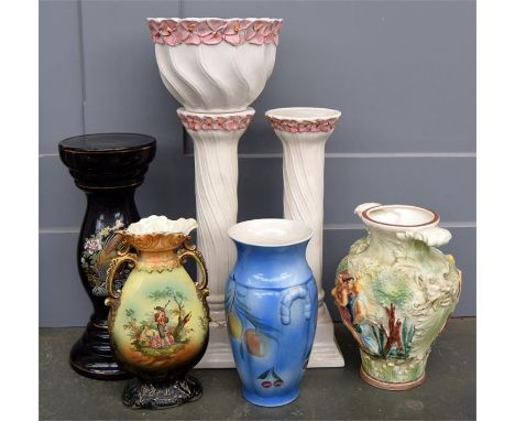 A pair of white ceramic urn stands, 50cmH, with one matching ceramic urn, a black ceramic urn stand decorated with a peacock,