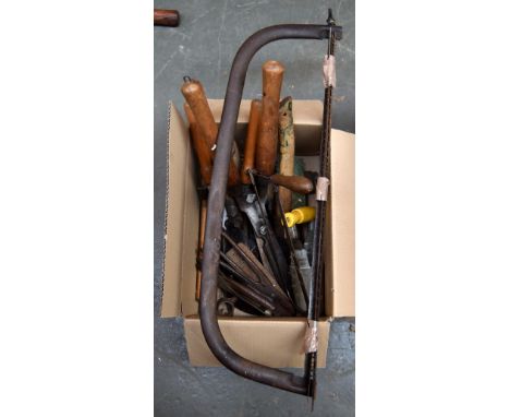 A box of tools to include garden clippers and a saw