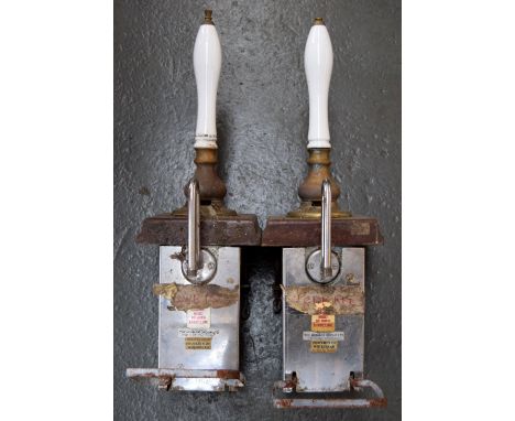 Breweriana: a pair of brass and ceramic ale pumps, with mahogany bases