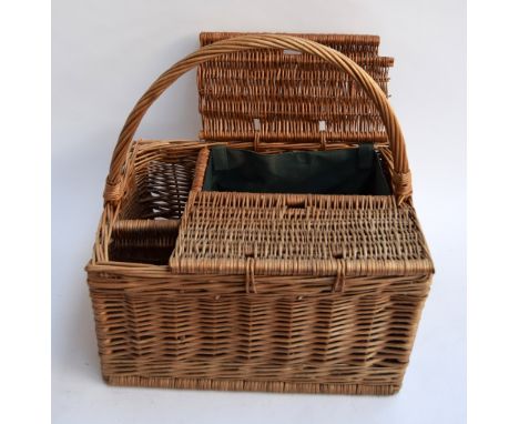 A wicker hamper with hinged top and removable liner, and hoop handle