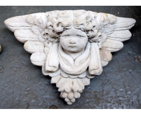 A wall mounted planter in the form of a cherub