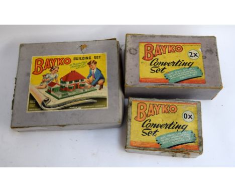 Three vintage Bayko building sets; a Bayko 0x Converting Set, a 2x Converting Set, and a building set