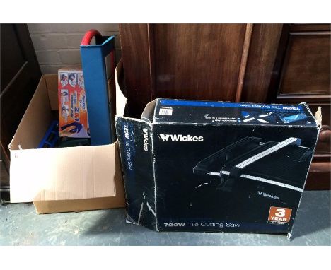 A box of tools including a Bosch circular saw and a Wickes 720W tile cutting saw