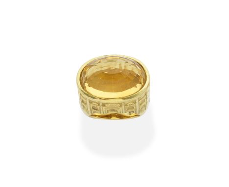 CITRINE DRESS RINGThe oval fancy-cut citrine within a raised setting engraved with the facade of the Taj Mahal, ring size app