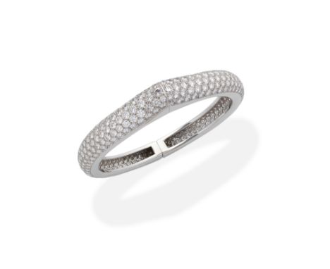 CARTIER: DIAMOND BANGLEPavé-set throughout with brilliant-cut diamonds, each half designed as a C-shaped link, hinged at the 