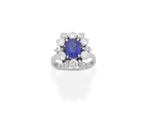 SAPPHIRE AND DIAMOND CLUSTER RINGThe central cushion-shaped sapphire within a surround of alternating brilliant and marquise-