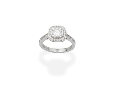 DIAMOND CLUSTER RINGSet with a cushion-shaped diamond, weighing 0.92 carats, in a halo surround of brilliant-cut diamonds to 