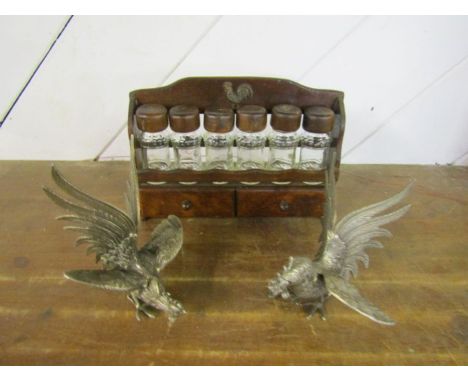 Pair of metal fighting cocks and vintage wooden spice rack with cockerel detail and glass spice bottles 