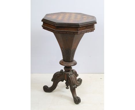 Victorian rosewood octagonal work table, the top inlaid with chess board, on tapering carved column and tripod base with scro