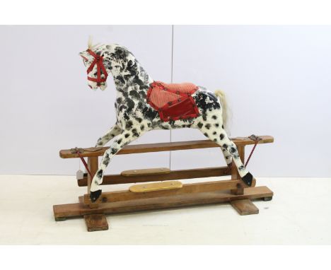 Early / mid 20th century carved wooden dappled painted rocking horse with red saddle and reins, 79cm high x 106.5cm long