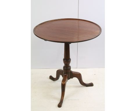 19th century mahogany tilt top table, the circular top with raised rim, with turned column and tripod base, 69.5cm high x 62.