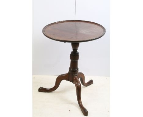 19th century mahogany tilt top table, the circular top with raised rim, with turned column and tripod base, 77cm high x 61cm 