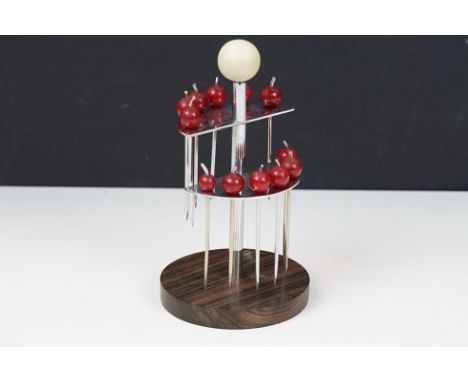 An Art Deco cocktail stick holder complete with cocktail sticks with cherry bakelite finials. 