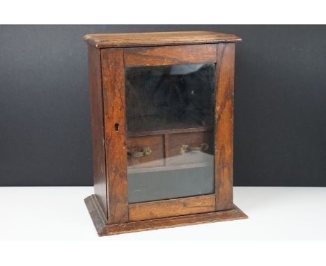 Glass fronted wooden smokers cabinet with pipe racks and double drawers with handles, H 36cm, W 30cm, D 20cm