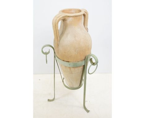 Large clay earthenware pot urn vase with handles stood on green tripod metal stand with loop handle detail, H 86cm