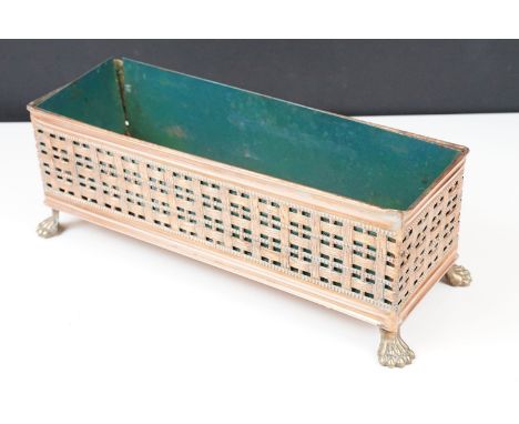 Copper planter with lattice work sides raised on brass lion paw feet, 31cm long