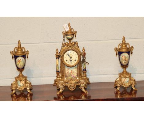 A German gilt metal and porcelain clock garniture, 20th century 