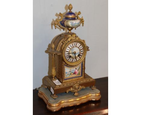 A French late 19th century gilt metal porcelain mounted striking mantel clock, twin barrel movement, striking on a bell and r