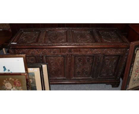 A late 17th century oak panelled coffer, hinged lid, bearing date, carved detail and bracket feet 