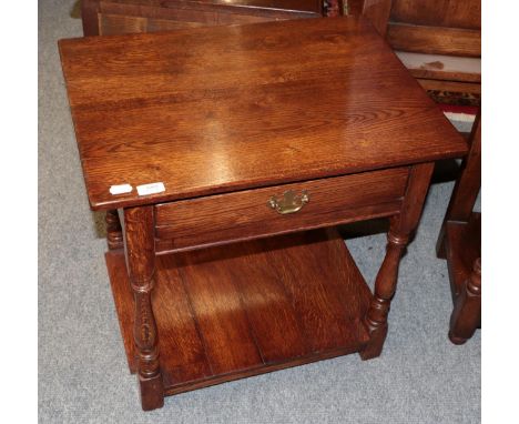 A Titchmarsh &amp; Goodwin style oak lamp table fitted with a drawer, 61cm wide by 46cm deep by 59cm high 