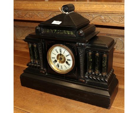 A Victorian ebonised architectural form striking mantel clock