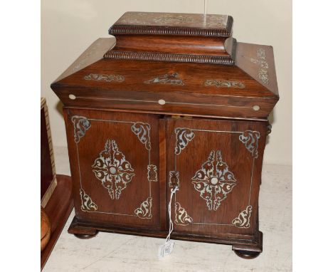 A Victorian mother-of-pearl inlaid rosewood box, oblong on bun feet, the hinged cover opens to reveal various implements, wit