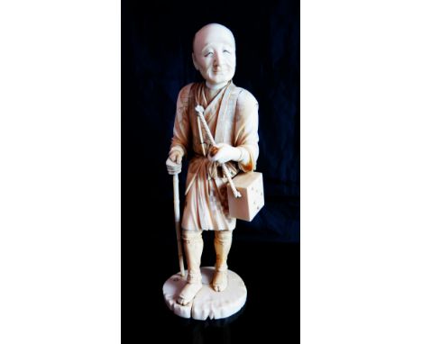 A Japanese Meiji Period Okimono of a man with staff and travelling box, signature to base, 29 cm high, item missing from hand