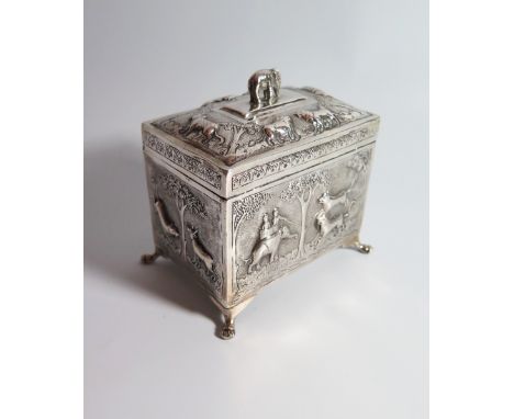 An Indian Silver Tea Caddy decorated with scenes of tigers and elephant and the hinge with elephant finial and with wooden in